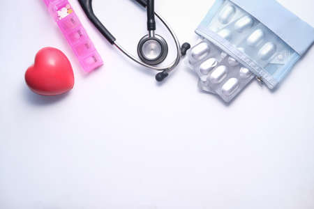 pill box, heart, and stethoscope on white backgroundの写真素材