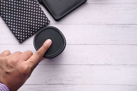 man hand using smart speaker and diary on tableの写真素材