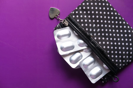 close up of blister pack on purple background