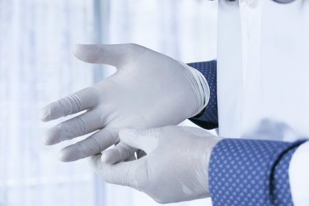 man doctor wears medical gloves.