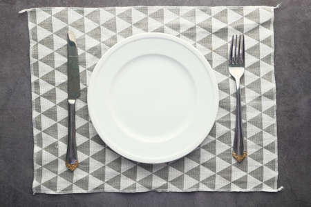 Fork and knife with empty plate, top downの写真素材
