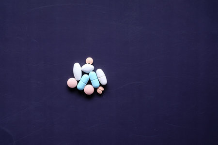 top view of colorful pills on dark background