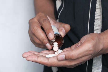 Close up of man hand taking medicineの写真素材