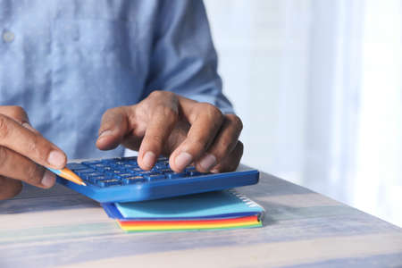 close up of accountant using calculator on office desk.の写真素材