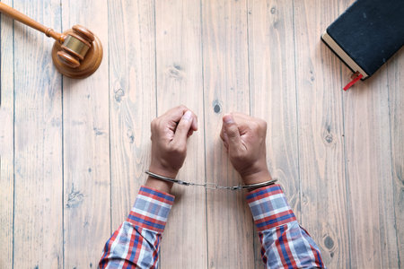 hands of a man with handcuffs close up.