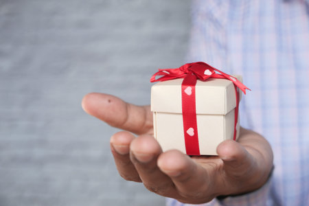 small heart shape gift on man hand close up