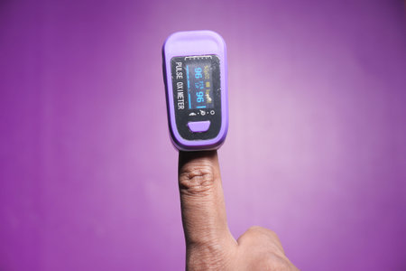 Man finger with pulse oximeter to measure oxygen saturation