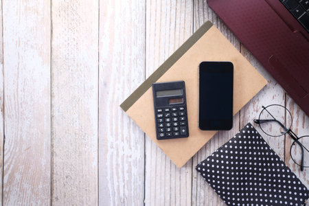 smart phone, laptop and notepad on table with copy space