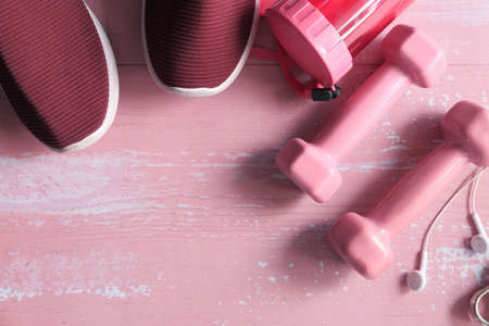 pink color dumbbell, shoe and headphone on pink backgroundの写真素材