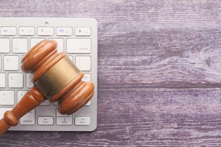 Top view of gavel on keyboard on tableの写真素材