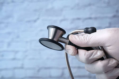 Close up of doctor hand holding stethoscope.の写真素材
