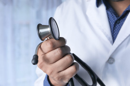 close up of doctor hand holding stethoscope indoorの写真素材