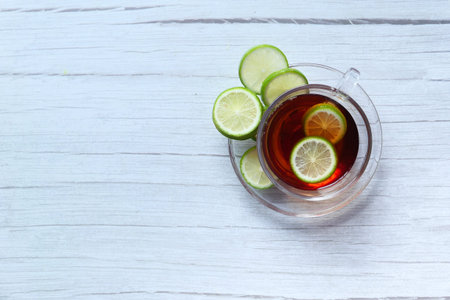 Top view of lemon tea on wooden background.