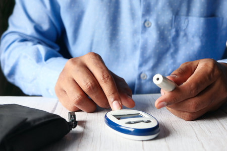 Top view of man hand measuring diabetic on table