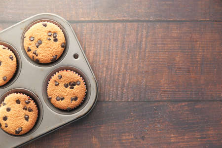 Top view of chocolate cup cake on wooden table.の写真素材