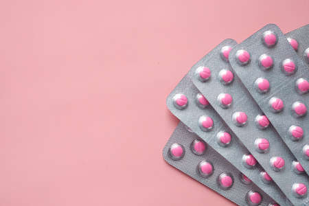 Top view of blister pack on pink backgroundの写真素材