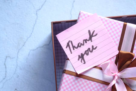 thank you message on gift box on tableの写真素材