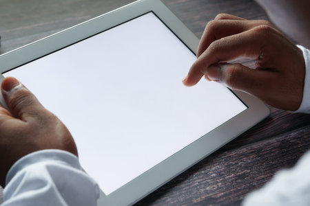 back view of person hand pointing on digital tablet