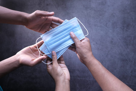 top view of mans hands holding face mask,