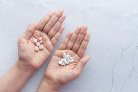 Hands of an young woman with pills.の写真素材