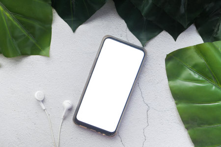 smart phone with empty screen and headphone on white background