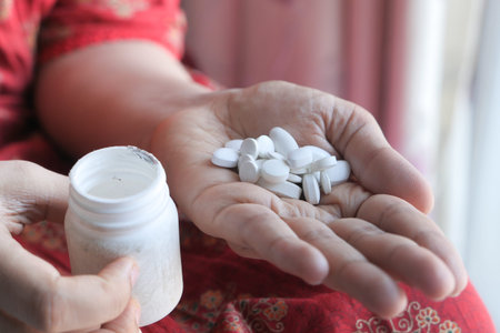 Close up of women hand taking pills