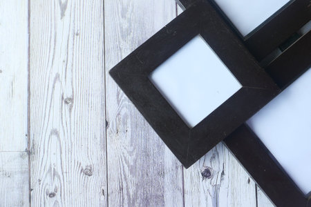 top view of empty frame on wooden background .