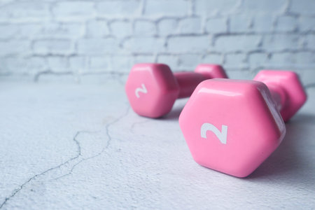 Fitness concept with dumbbell on white background with copy space