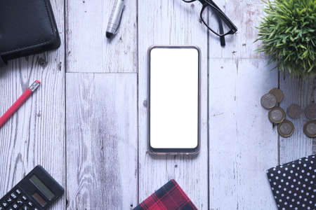 flat composition of smart phone and office suppliers on tableの写真素材