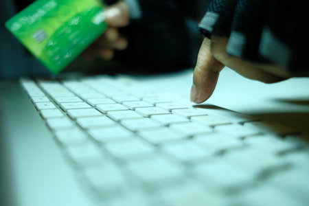 hacker hand stealing data from laptop top down