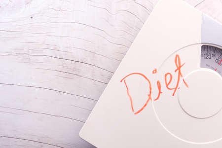 diet text on weight scale on wooden table, top viewの写真素材