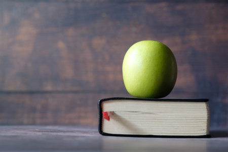 black to school concept with apple on notepad on table.