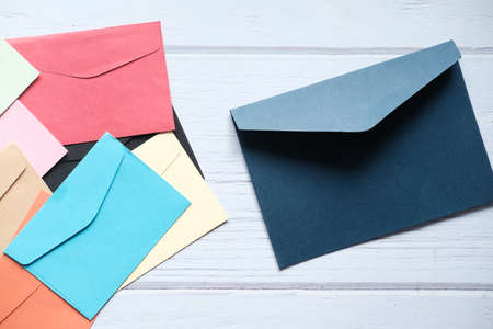 colorful envelope on wooden background top viewの写真素材
