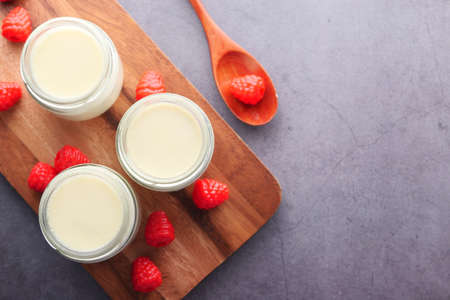 Top view of fresh yogurt in a bowl on black backgroundの写真素材