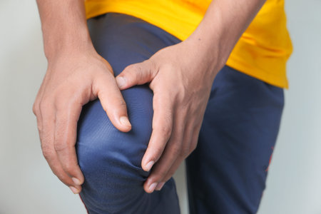 Close up on man suffering knee joint pain