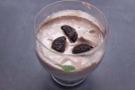 chocolate milk shake in a glass on black background.