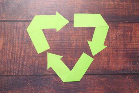 Recycled arrows sign on wooden tableの写真素材
