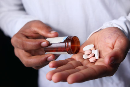 Close up of man hand taking medicine