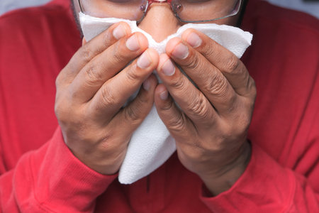 Sick man got flu allergy sneezing and blowing nose