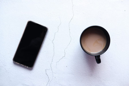 flat composition of smart phone and coffee on table
