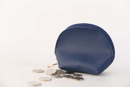 coins in a small leather bag isolated in whiteの写真素材
