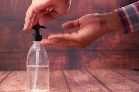 close up of young man hand using sanitizer gel for preventing virusの写真素材