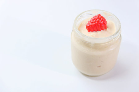 close up of fresh yogurt in a bowl on white background