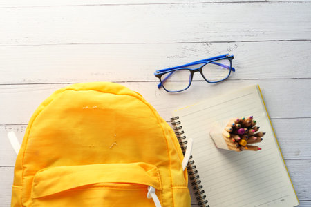 Back to school concept yellow backpack on table