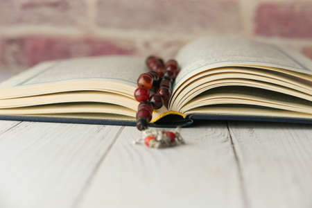 Holy book Quran and rosary on table, close upの写真素材