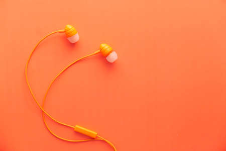 earphone on orange background with copy spaceの写真素材