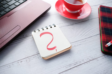 Close up of f question mark on paper on office desk