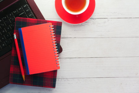 flat composition of laptop and office stationary on wooden deskの写真素材
