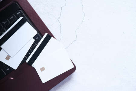 high angle view of credit cards on laptop on white backgroundの写真素材