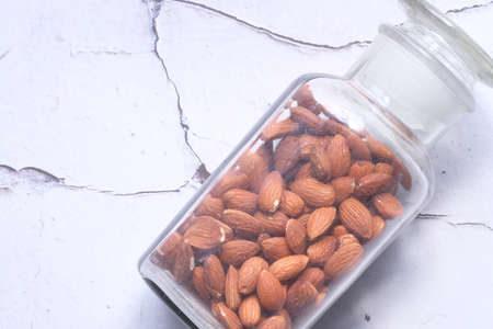 top view of almond nuts in a container on tableの写真素材